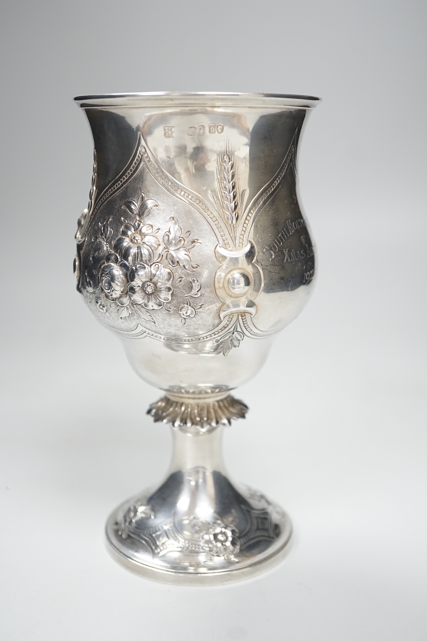 A Victorian silver presentation pedestal cup, embossed with a bull, with later engraved inscription, Edward & John Barnard, London, 1863, 21cm, 13.1 oz.